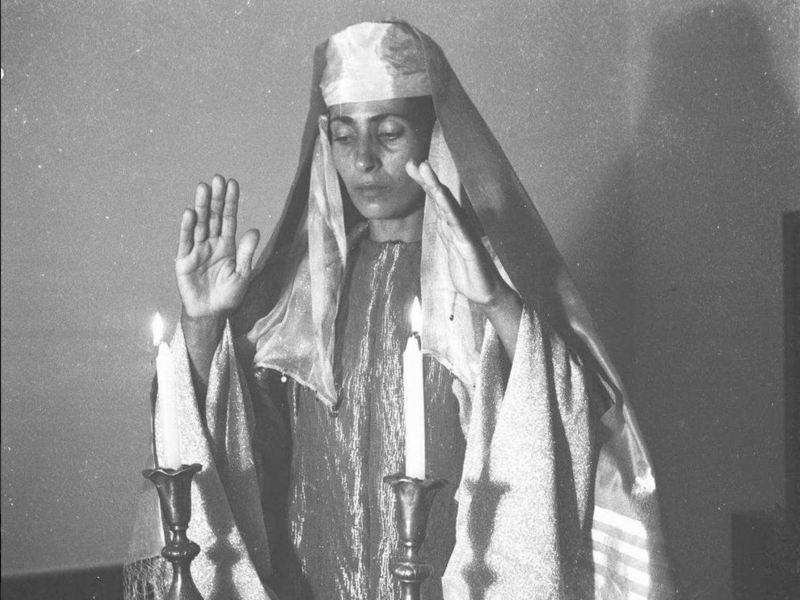 Yemenite ballerina Rachel Nadav lighting Shabbat candles, 1945. Photo by Zoltan Kruger via Israel State Archives.