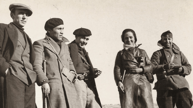 black and white historical photo of four men and one woman wearing heavy clothes
