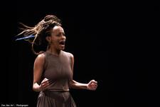 Dege Feder posing with her hands in fists, mouth open as if singing or shouting