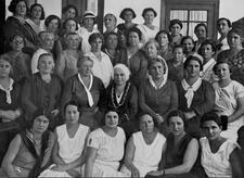 black and white historical photo of a large group of women