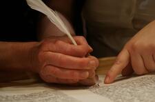 Hands scribing Torah