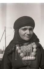 A woman wears jewelry handmade by a goldsmith in Hatzermat, Yemen. 1964. 