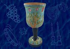 Blue kiddush cup on dark blue patterned background