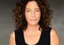 Headshot of Michelle Azar. She is a light skinned woman with brown curly hair and is wearing a black scoop neck tank top.