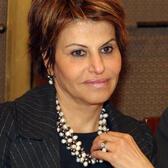 image of a woman with short brown hair in a black suit