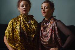 photograph of two women in bright clothing