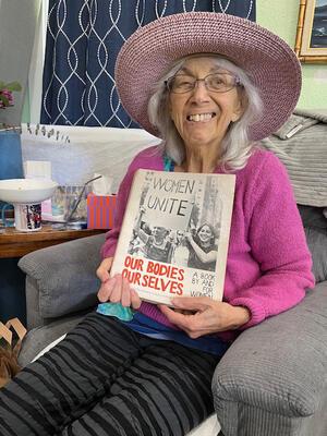 Paula Doress-Worters with an original copy of Our Bodies, Ourselves.
