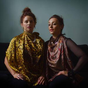 photograph of two women in bright clothing