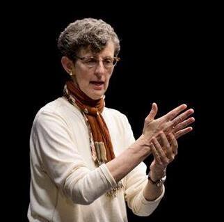 Miriam Huberman speaking on a stage
