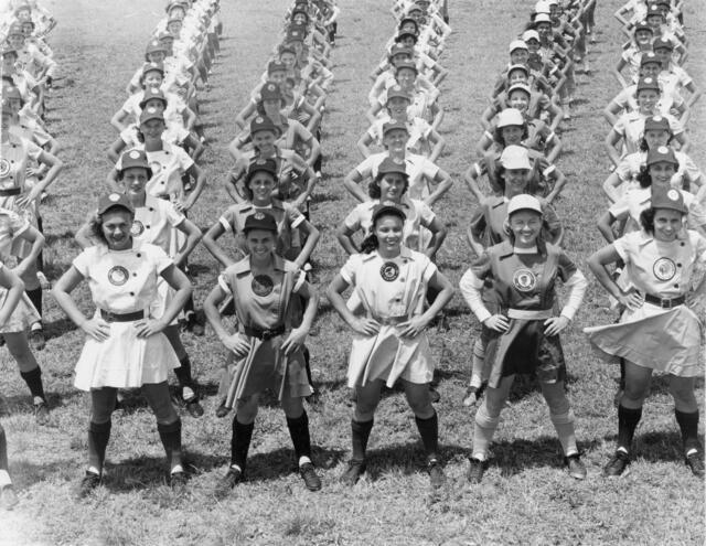 Rows of young women in baseball uniforms with hands on hips