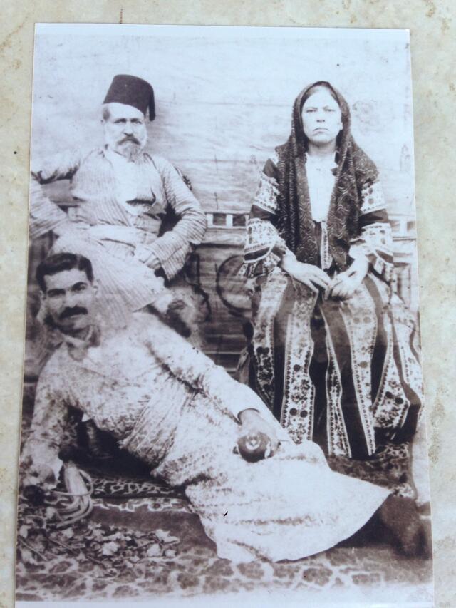 Jacob Jonah reclining in front of his parents, seated in chairs