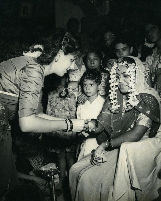 Artist Siona Benjamin's mother Sophie applying henna on the hands of her sister-in-law Diana. Mumbai, India, 1950's.