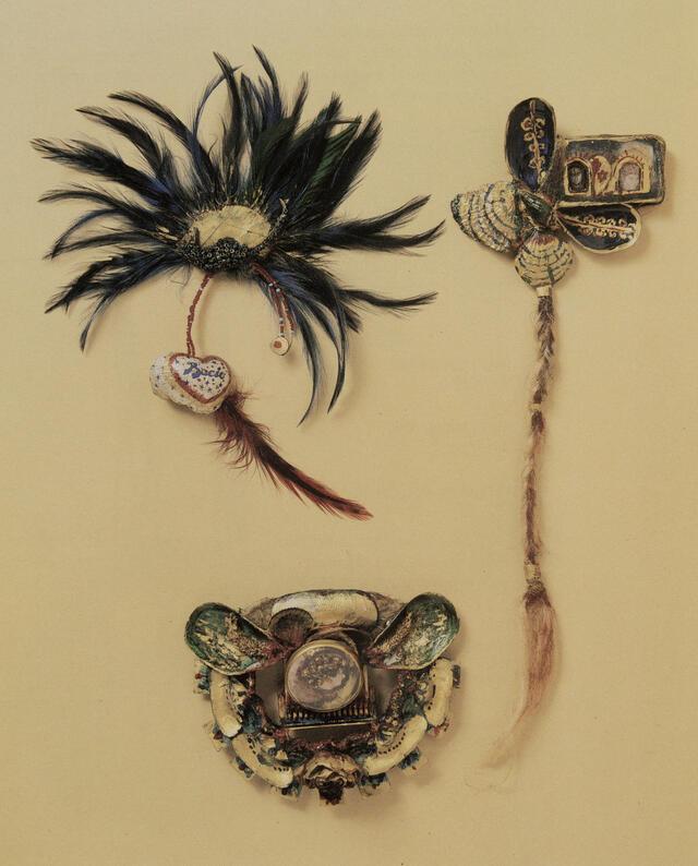 three pieces of jewelry using feathers, rope, and found objects, on cream-colored background