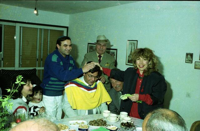 The mayor of Lod visits residents' homes on the night of Mimouna in Lod, Israel. 1991-1994.