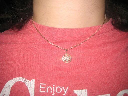 Star of David necklace on a red shirt